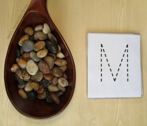 Simple preschool letter recognition practice using rocks! A fun learning activity using loose parts and a free printable